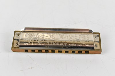 Lot 139 - Four cased harmonicas to include a super...