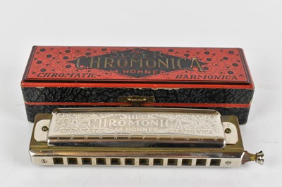 Lot 139 - Four cased harmonicas to include a super...