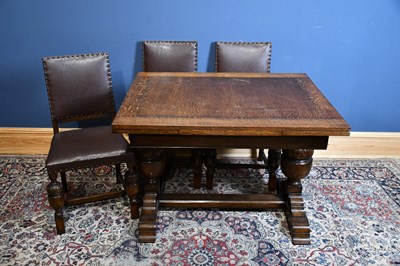 Lot 287 - A 1920s carved oak extending dining table and...