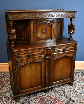 Lot 290 - A 1930s carved oak court cupboard, with door...