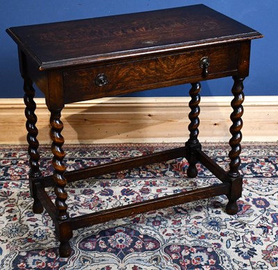 Lot 304 - A 1920s oak side table, with drawer, on turned...