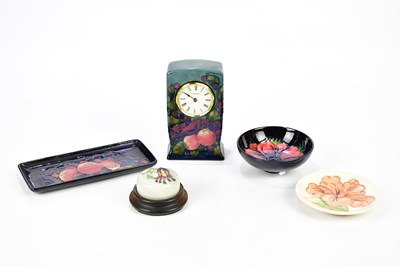 Lot 1276 - MOORCROFT; five pieces including a mantel...