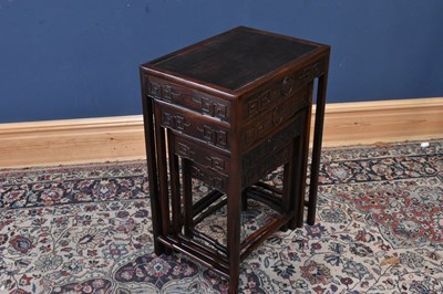 Lot 1249 - A nest of four Chinese carved hardwood tables,...