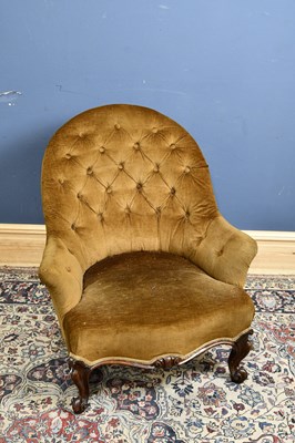 Lot 122 - A Victorian button back armchair, on scrolling...