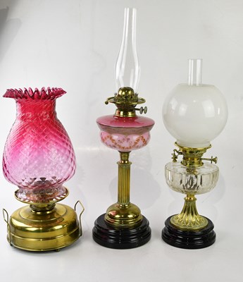 Lot 2197 - A brass oil lamp with a large cranberry glass...