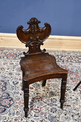 Lot 121 - A 19th century mahogany hall chair with carved...