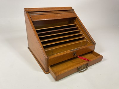 Lot 18 - A tambour front light oak desk tidy with...