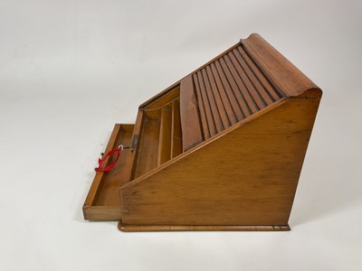 Lot 18 - A tambour front light oak desk tidy with...