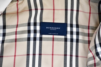 Lot 903 - BURBERRY; a short cream lady's trench coat...