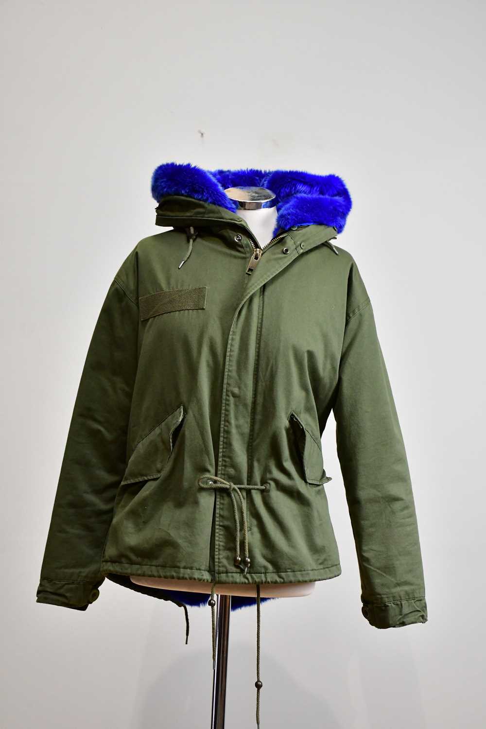 Lot 906 - MO OMO OKONG; a khaki cotton jacket with hood...