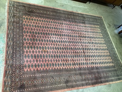 Lot 592 - A large terracotta Bokhara rug, 440 x 320cm