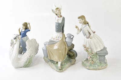 Lot 1425 - LLADRO; three large figures including a girl...