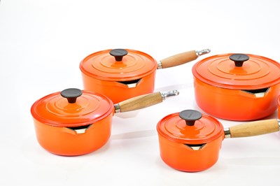 Lot 1201 - COUSANCES; a collection of orange cast iron pans.