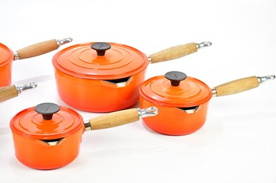 Lot 1201 - COUSANCES; a collection of orange cast iron pans.