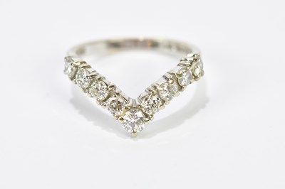 Lot 125 - An 18ct white gold nine stone diamond wishbone...