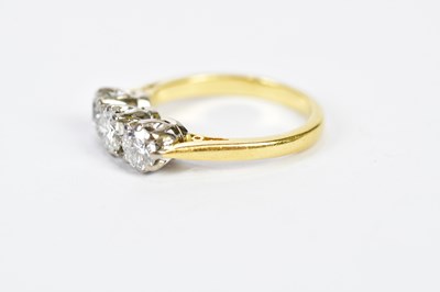 Lot 77 - An 18ct yellow gold three stone diamond ring,...