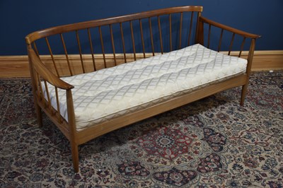 Lot 316 - A mid century teak settee/day bed on turned...