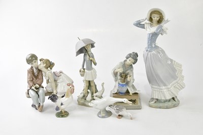 Lot 1419 - LLADRO; a large figure of a girl holding her...