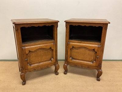 Lot 680 - A pair of French oak bedside cabinets with...