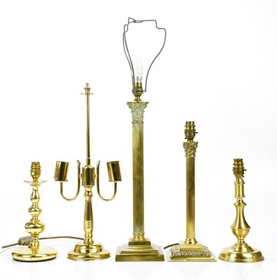 Lot 2229 - A group of five brass lamps, to include two...