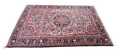 Lot 352 - An Eastern style blue ground rug with floral...