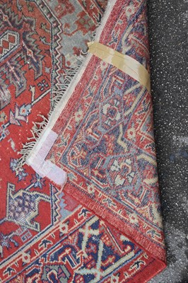 Lot 359 - An Eastern style red ground with geometric...