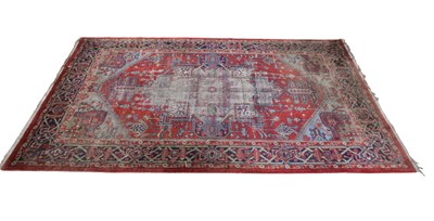 Lot 359 - An Eastern style red ground with geometric...