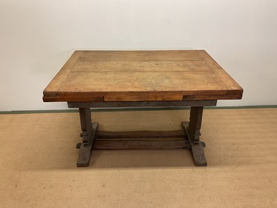 Lot 658 - An Arts and Crafts oak extending table with...