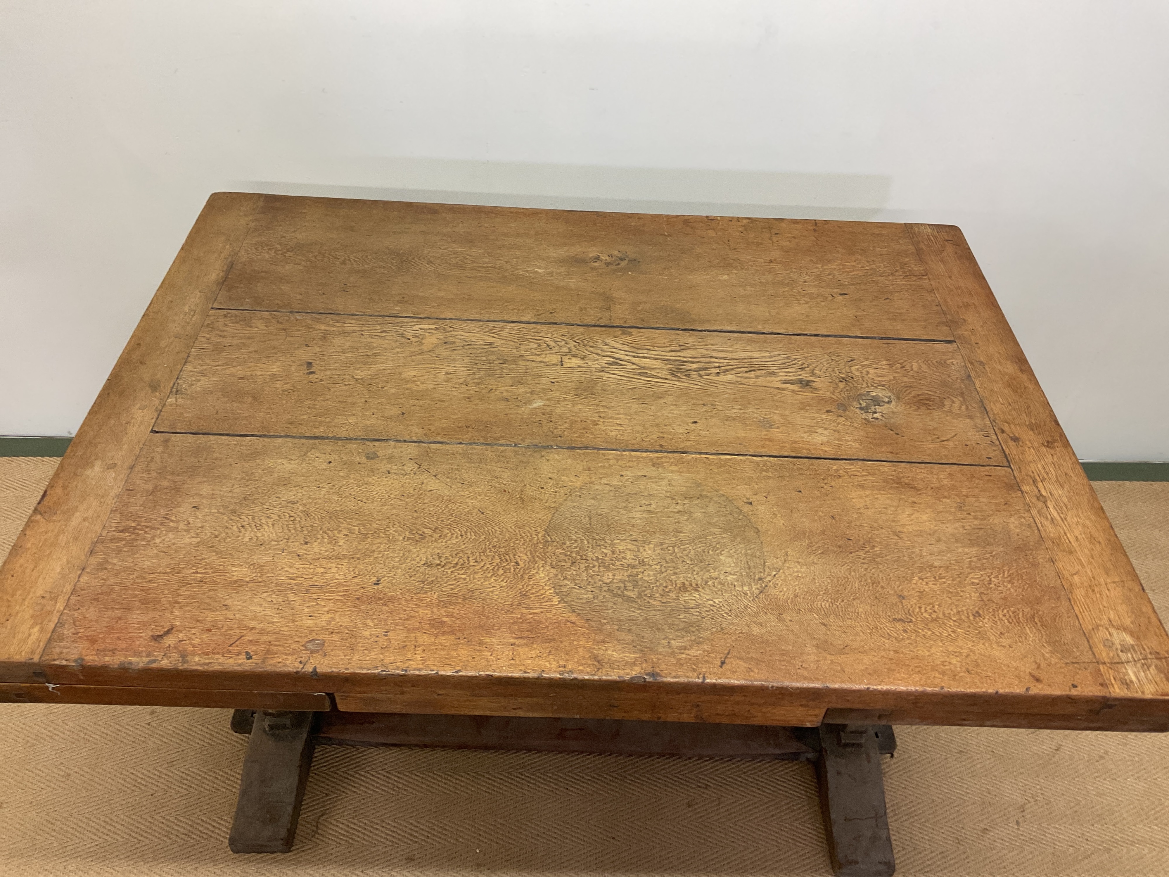 Lot 658 - An Arts and Crafts oak extending table with