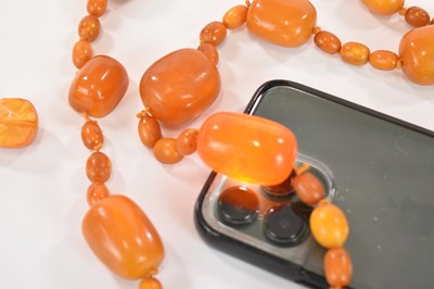 Lot 1269 - An early egg yolk/butterscotch amber bead...
