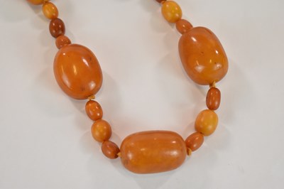 Lot 1269 - An early egg yolk/butterscotch amber bead...