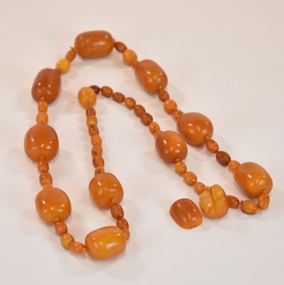 Lot 1269 - An early egg yolk/butterscotch amber bead...