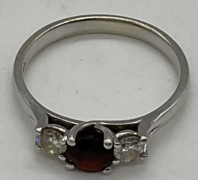 Lot 490 - A 9ct white gold garnet and diamond three...