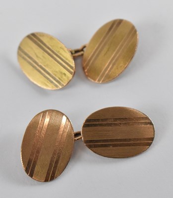 Lot 668 - A pair of 9ct yellow gold oval cufflinks,...