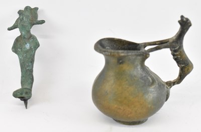 Lot 553 - A Benin bronze jug with stylised dog handle...