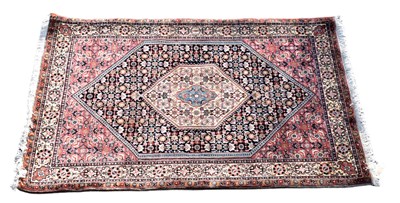 Lot 335 - A Persian designed rug with lozenge shaped...