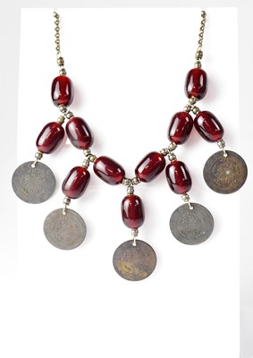 Lot 799 - A Turkish cherry amber coloured bead necklace...