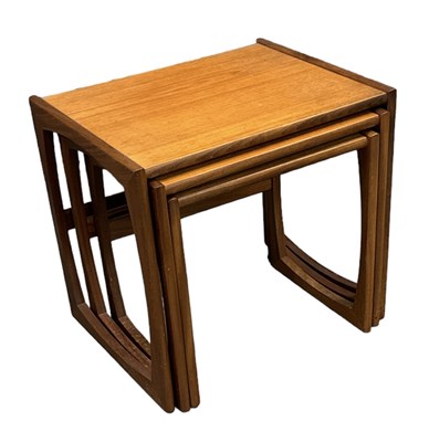 Lot 97 - A mid century teak nest of three tables,...