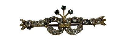 Lot 702 - A 9ct yellow gold brooch set with three small...