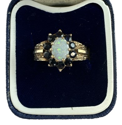 Lot 705 - A 9ct yellow gold opal and garnet set ring,...