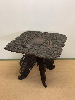 Lot 669 - An Anglo Indian carved hardwood folding table,...