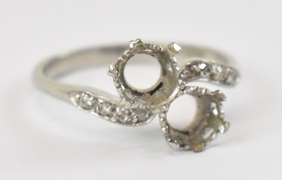 Lot 703 - A platinum dress ring set with four small...