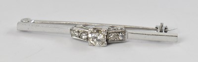 Lot 687 - A white metal diamond set bar brooch, the...