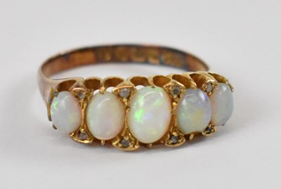 Lot 661 - An 18ct yellow gold ring set with five opals,...