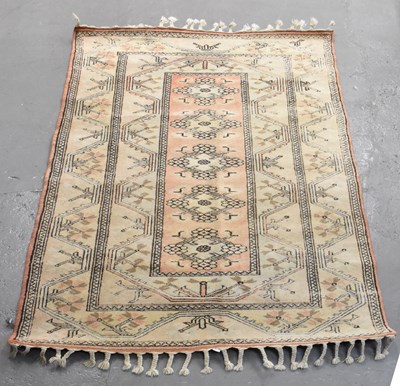Lot 140 - A modern cream and red ground rug with...