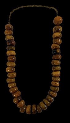 Lot 683 - A strand of butterscotch amber beads, length...