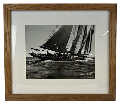 Lot 292 - A black and white photograph of a boat off...