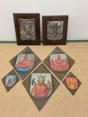 Lot 22 - Two silver plated coats of arms mounted on oak...
