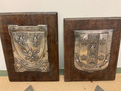 Lot 22 - Two silver plated coats of arms mounted on oak...