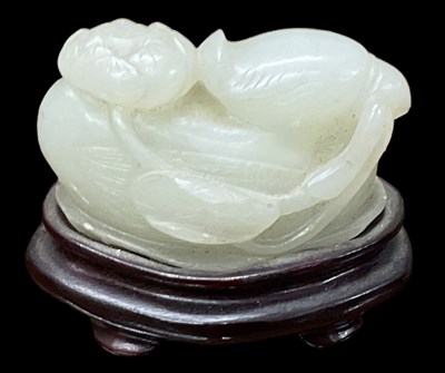 Lot 1053 - A Chinese jade modelled as a bird, on hardwood...